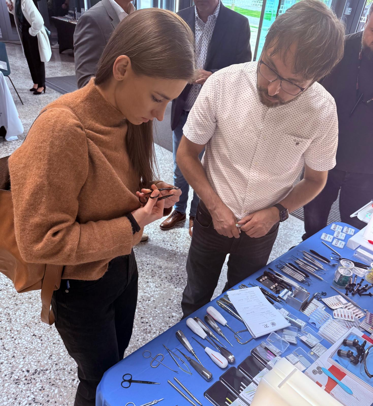 Dental professionals exploring ErgoDenta instruments at the Janouch Dental booth