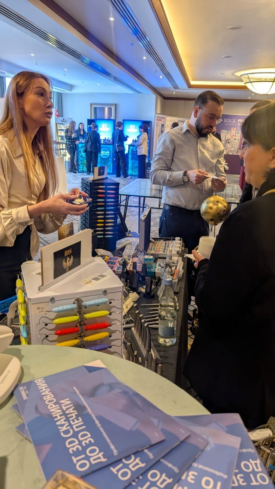 Clinicians reviewing ErgoDenta instruments at the IDS Georgia booth